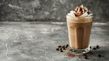 Glass cup of tasty frappe coffee on grey table