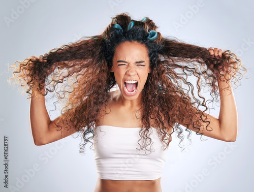 Angry, beauty and hair with woman screaming in studio on gray background for grooming problems. Curly, frizzy or messy with frustrated African model shouting at salon for keratin or shampoo treatment
