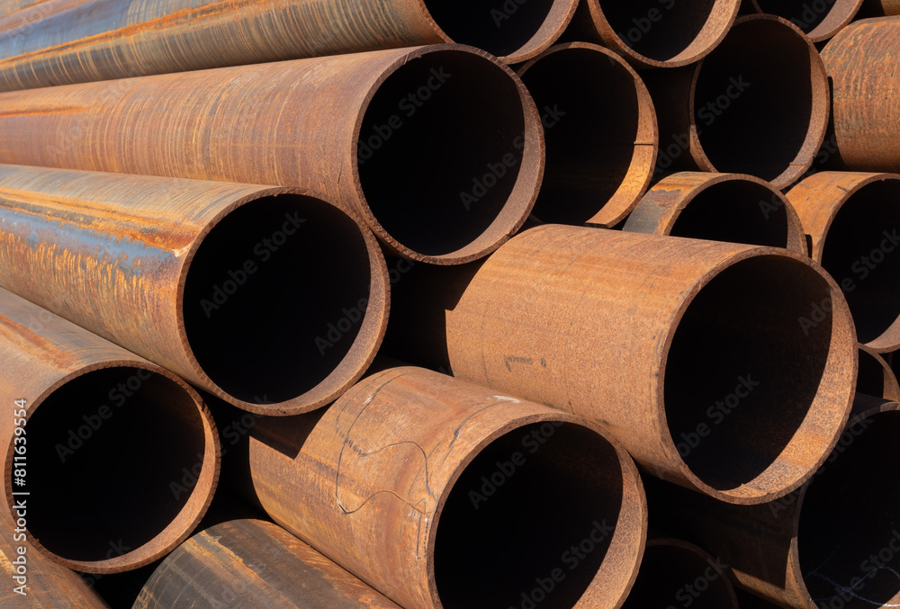 rusty steel pipes stacked on a construction site rusty steel pipes stacked on a construction site