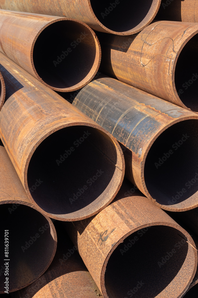 rusty steel pipes stacked on a construction site