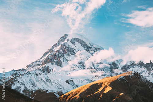 Georgia. Peak Of Mount Kazbek Covered With Snow. Kazbek Is A Stratovolcano And One Of Major Mountains Of Caucasus. Beautiful Georgian Nature Landscape In Early Winter. photo