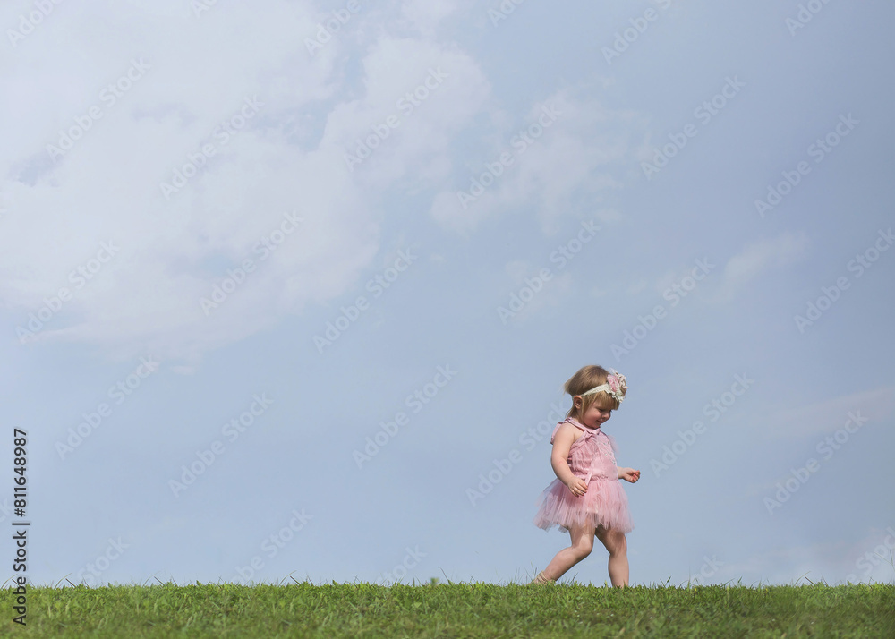 Little blonde girl in pink dress exploring in the clouds Little blonde girl in pink dress exploring in the clouds