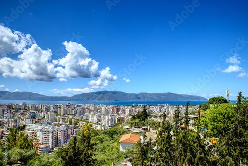 Panorama of Vlora City in Albania from Kuzum Baba view point in summer sunny day with blue sky and clouds