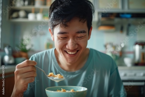 Asian man smiling while having breakfast at home