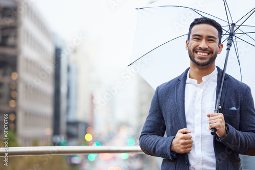 Businessman, outdoor and umbrella with happiness in city for justice, advocate for legal at building. Male lawyer, rain and parasol for safety in urban with smile, attorney in New York for court