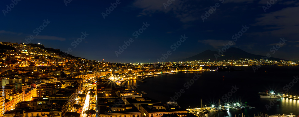 Fototapeta premium beautiful night panorama of Naples city with nice lights streets flashlights and buildings and volcano Vesuvius with amazing sky on background