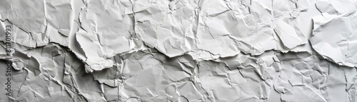 The image is a close-up of a crumpled piece of white paper. The paper is textured and has a rough surface. The image is well-lit and the colors are bright and vibrant.