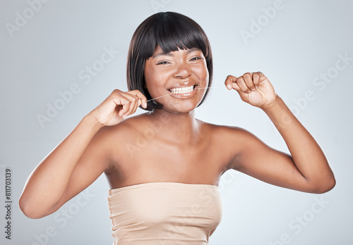 Happy, portrait and black woman with dental floss for clean teeth on a white studio background. Young female person or African model with smile for tooth whitening, cavity or oral, mouth or gum care