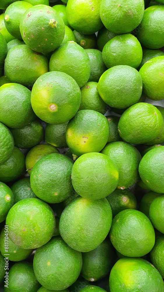 Close up pile of tasty fresh limes sold at the market as a background. Close up pile of tasty fresh limes sold at the market as a background.
