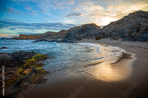Sunset view of Minas Cove in the Cabo Cope and Puntas de Calnegre Regional Park, with crystal clear waters and colorful sky photo