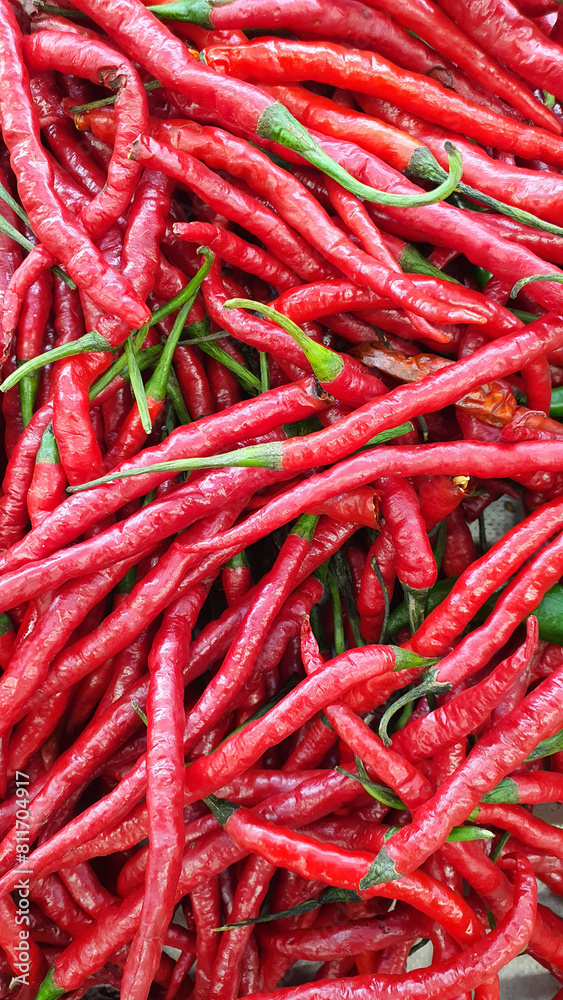 Close up pile of fresh red chilli placed together in local market as a background Close up pile of fresh red chilli placed together in local market as a background