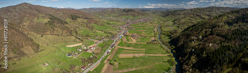 Road follows Iza River through the scenic Carpathian Mountains valley in Maramureș.Hilly terrain provides charming views of distant snow-capped peaks.Nestled between villages Bârsana Strâmtura. photo