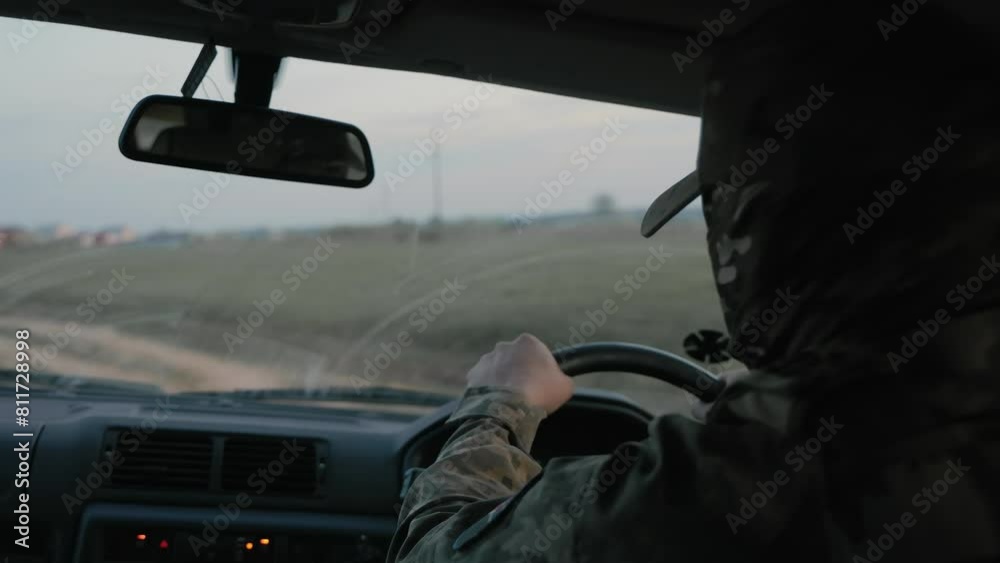 A soldier of the Ukrainian army drives a military car. War in Ukraine A soldier of the Ukrainian army drives a military car. War in Ukraine