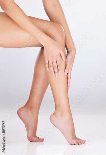 Studio  skincare and legs of woman by mockup space for grooming  wellness and self care. Female model  hands and hair removal as treatment  glowing and smooth skin with cosmetics by white background