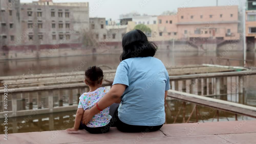 isolated young mother and cute toddler son enjoying togetherness sitting at outdoor at evening isolated young mother and cute toddler son enjoying togetherness sitting at outdoor at evening