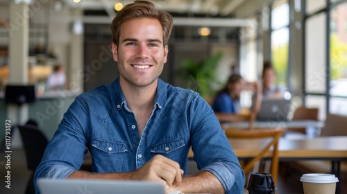 Smiling Man with Laptop at Cafe photo