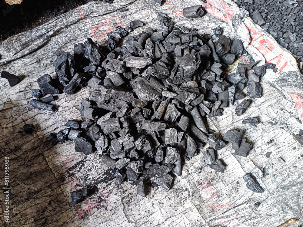 Black gray charcoal materials photographed during the daytime. Used charcoal in the garden of the village house.used for ironing. Black gray charcoal materials photographed during the daytime. Used charcoal in the garden of the village house.used for ironing.