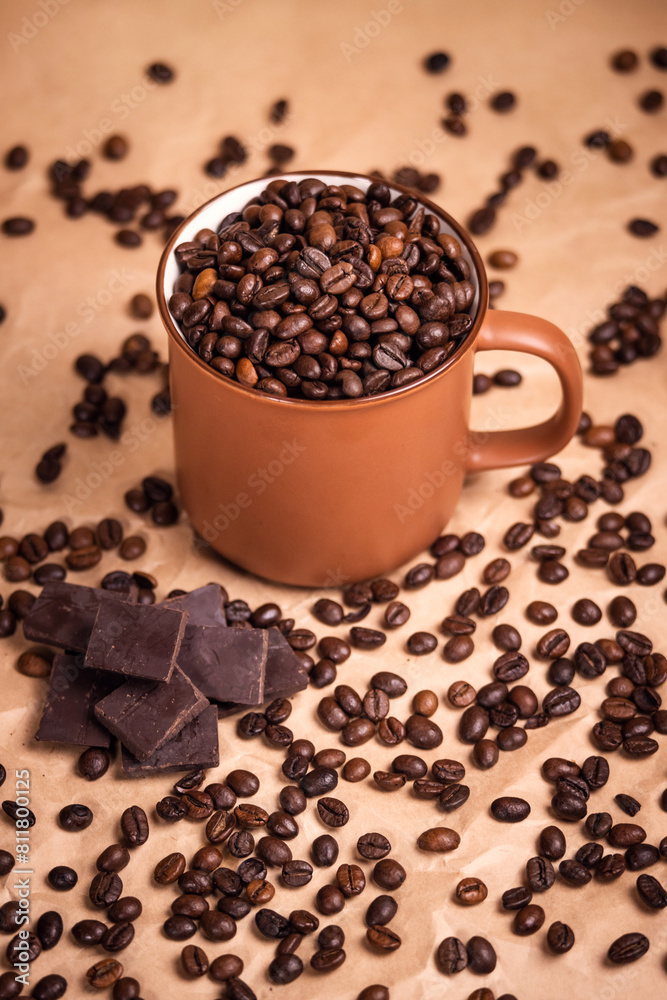 many macro aromatic coffee beans in a cup  on the background.