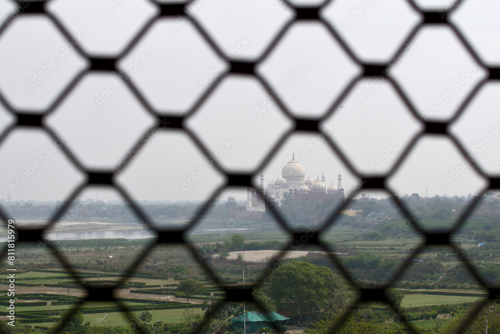 Naklejka premium Agra, India: Taj Mahal. Seen from the red fort. The son of the Taj Mahal builder imprisoned his father. From his prison he had a view of taj mahal