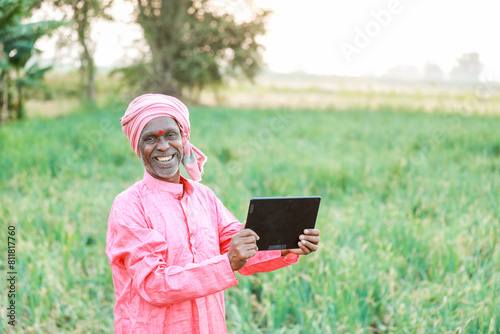 Indian farm worker holding tablet