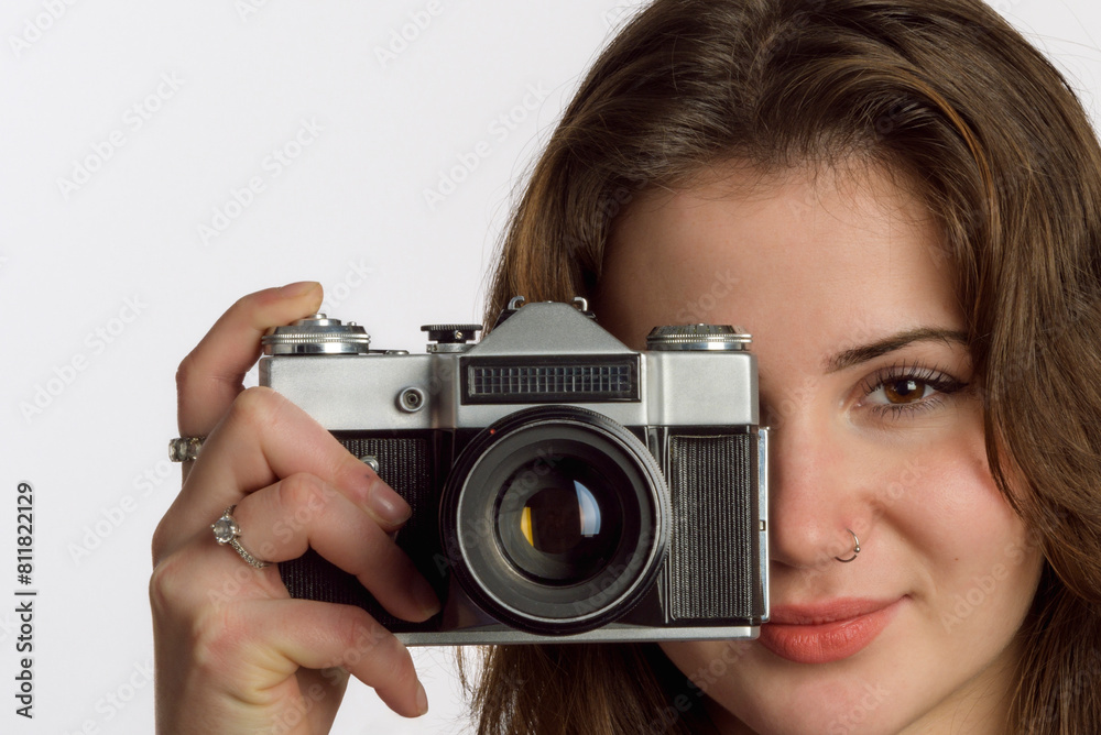 Portrait of a young girl with a retro camera from the 60s and 70s. Portrait of a young girl with a retro camera from the 60s and 70s.