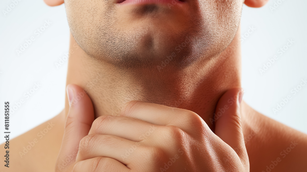 Obraz premium Close-up of a man's lower face and neck, highlighting his fingers gently pressing into his skin, possibly suggesting discomfort or examination.