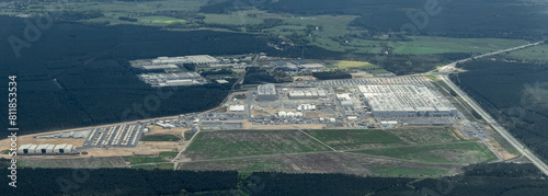 Gruenheide, Brandenburg, Germany - panoramic aerial landscape view of area around Tesla Gigafactory Berlin-Brandenburg located in a forest area southeast of Berlin with car production line 