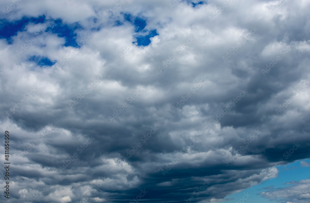 White and dark clouds on a blue sky. White and dark clouds on a blue sky.