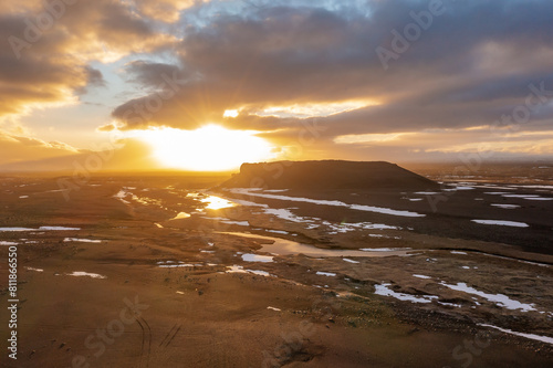 Cloudy sunset drone view of frozen lake on swamps on mountain hills. Iceland, north-eastern region. photo