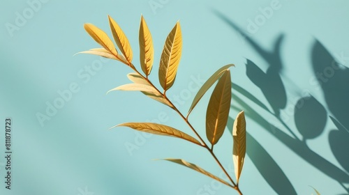 Golden leaves with shadows on light blue background  background image 
