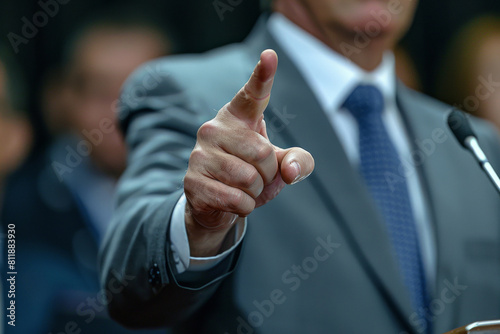 Assertive Businessman Pointing Forward, Emphasizing Leadership and Decision-Making in a Speech