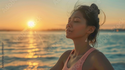 An Asian young woman gracefully performs the Gomukhasana pose by the sea engaging in advanced yoga for stretching strengthening and relaxation embodying the essence of holistic health care photo