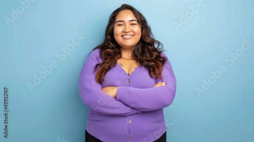 A plus size Hispanic woman in a purple sweater smiling for a picture