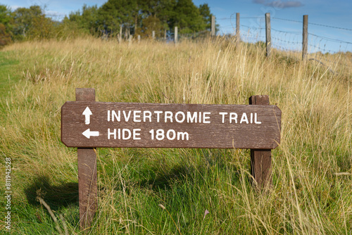 A wooden sign for the Invertromie Trail at Insh Marshes, Badenoch and Strathspey, Highland, Scotland, UK. Horizontal landscape format. photo