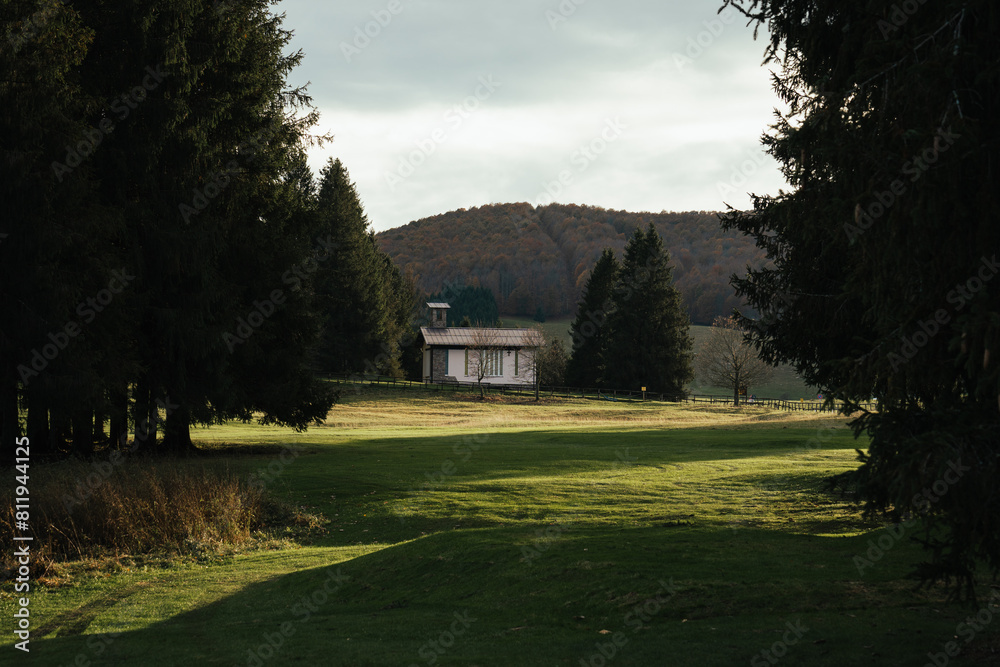 Isolated church during sunset in the fields of the Cansiglio highland Isolated church during sunset in the fields of the Cansiglio highland