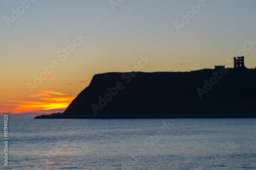 The headland at the southern end of North Bay in Scarborough, North Yorkshire, UK, at sunrise. photo