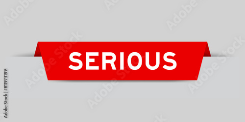 Red color inserted label with word serious on gray background