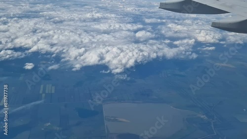 The view from the window of an air plane to the clouds, blue sunny sky.