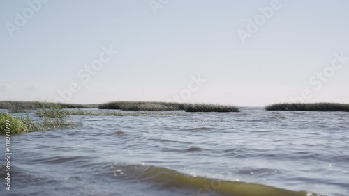 Slow motion of small waves of gulf of finland in summer photo
