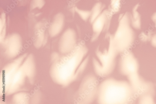 Leaf shadow and light on wall pink background. Nature tropical leaves tree branch and plant shade.Sunlight from sunshine on wall texture for foliage mockup background wallpaper, shadow overlay effect