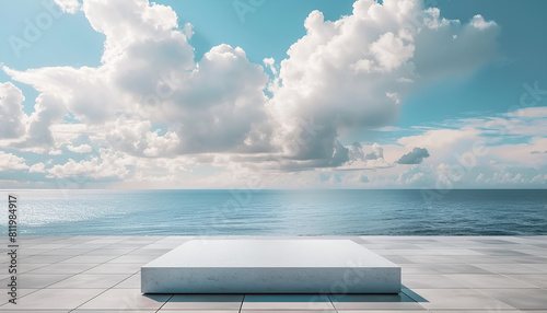 white concrete podium on a tile floor  against a serene ocean and cloudy sky background