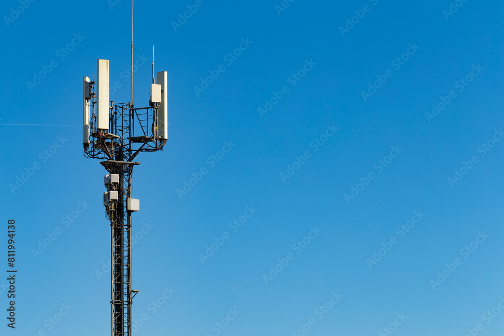 Telecommunication tower of 4G and 5G cellular. Macro Base Station. Mobile phone tower. Telecommunication cell phone tower against a blue sky
