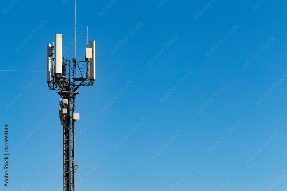 Telecommunication tower of 4G and 5G cellular. Macro Base Station. Mobile phone tower. Telecommunication cell phone tower against a blue sky Telecommunication tower of 4G and 5G cellular. Macro Base Station. Mobile phone tower. Telecommunication cell phone tower against a blue sky