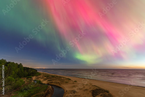 Fototapeta Naklejka Na Ścianę i Meble -  Aurora Borealis northen lights on the Baltic Sea beach in Latvia at May.