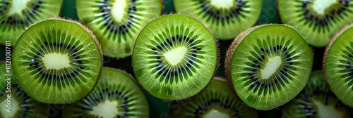 kiwi fruit, including sliced and whole kiwis, are arranged in a row from left to right