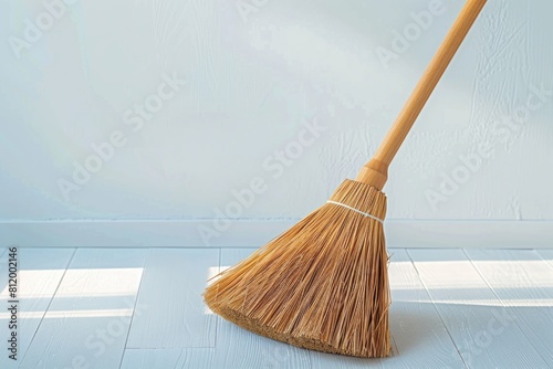 A broom sitting in a room. Suitable for household or cleaning concepts