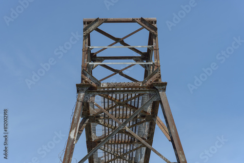 metal rail signal tower on a blue sky photo