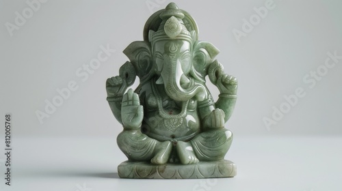 Ganesha figurine crafted from jade, positioned on a white background to highlight its fine details