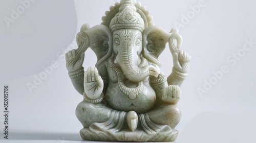 Ganesha figurine crafted from jade  positioned on a white background to highlight its fine details