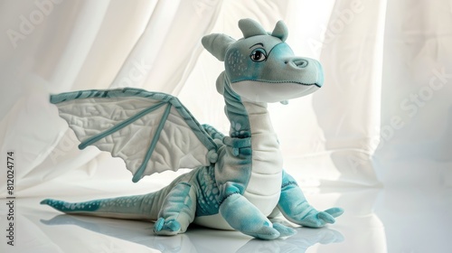 Aqua colored dragon plushie doll elegantly perched on a white backdrop casting a shadow reflection This charming dinosaur stuffed puppet exudes a playful vibe resembling a lively lizard toy 